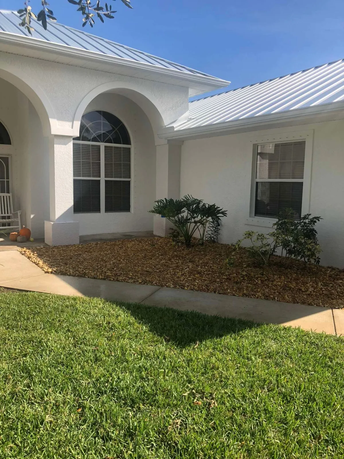 Finished front entry planting bed with fresh mulch and new shrubs